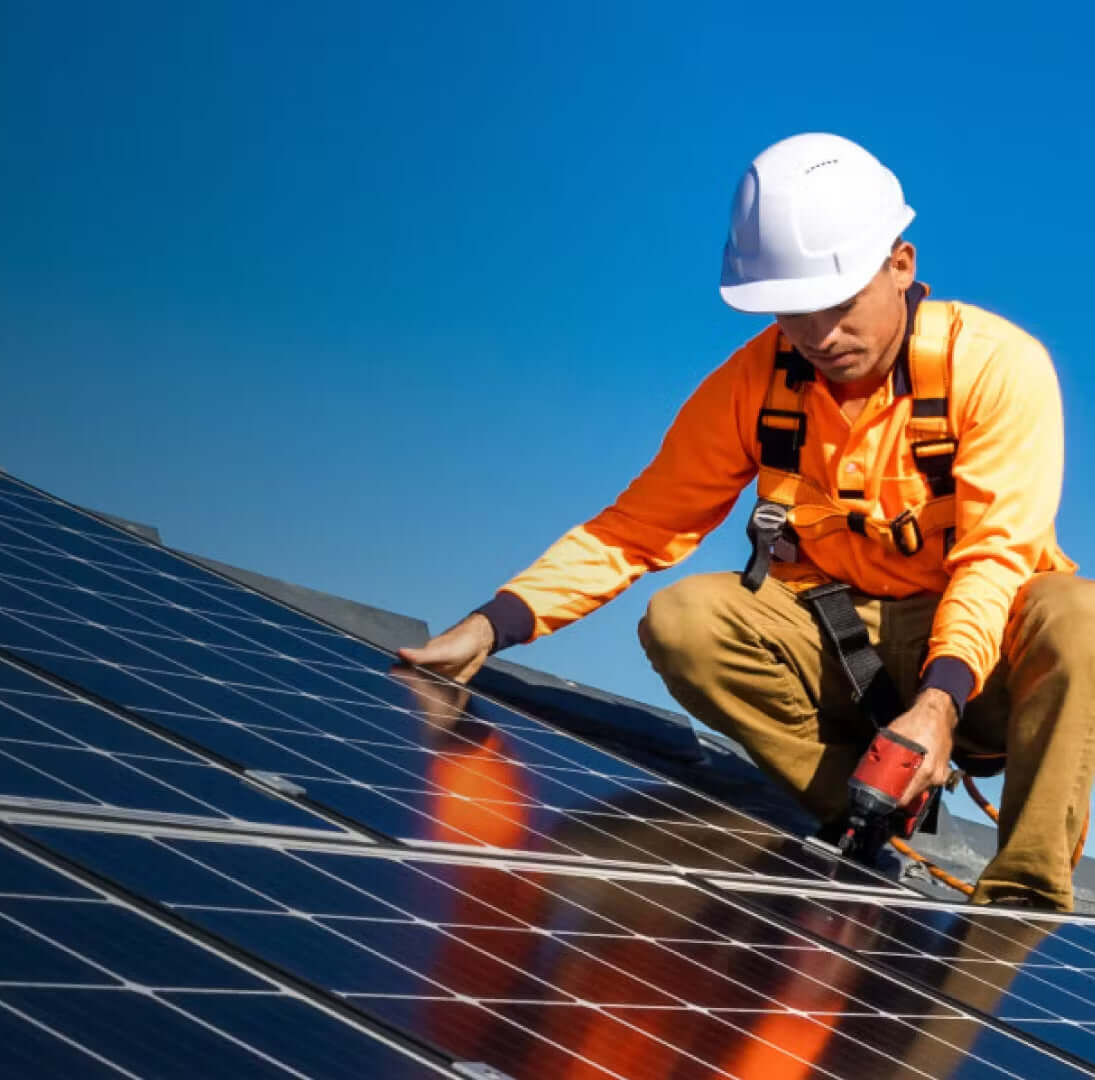 Modern suburban home with solar panels and a “Sold Above Asking” real estate sign.