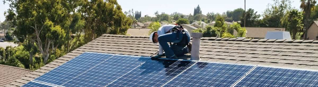Rooftop solar and net metering: The facts - a technician installing solar panels on a roof.