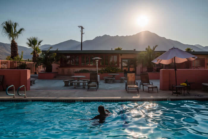 Average Electric Bill for a 3-Bedroom Home in Palm Springs, sunny poolside view with mountains in the background.