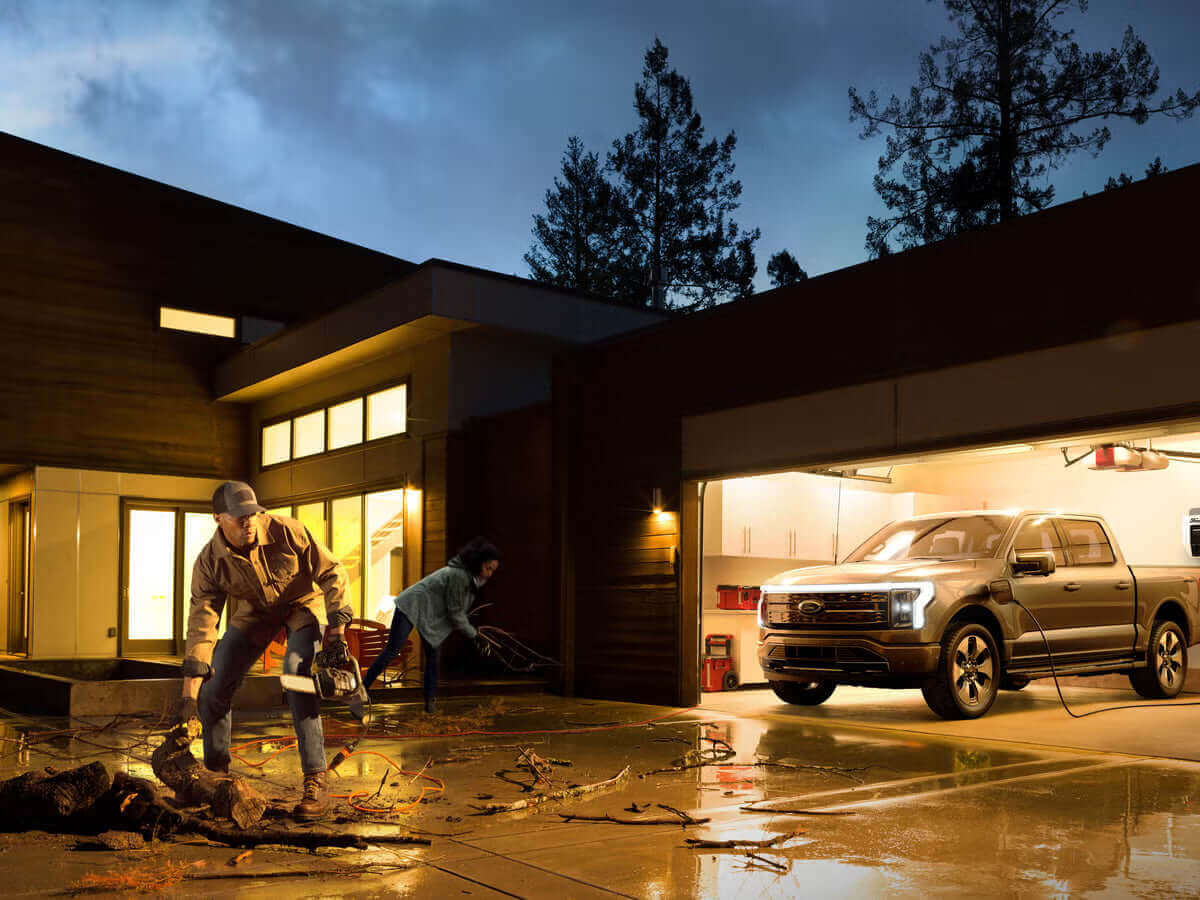 Could an EV power a home in an emergency: a family preparing for a storm with an electric vehicle in the garage.