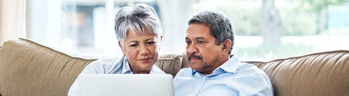 Couple researching 10 things you should know before installing solar panels on a laptop.
