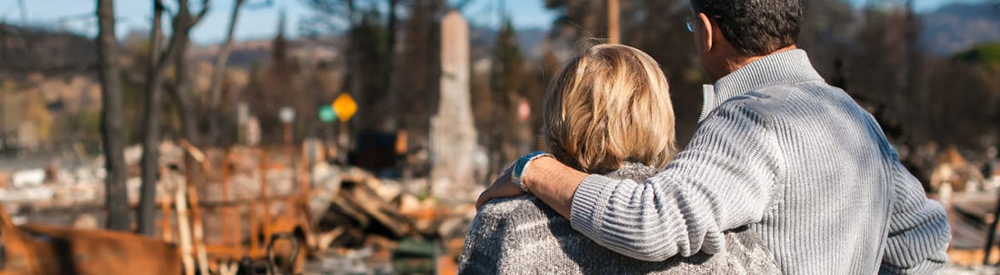 Home solar power can help prevent wildfires couple observing wildfire damage together.